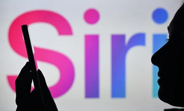 Silhouette of a person using a smartphone with the Siri logo in the background.