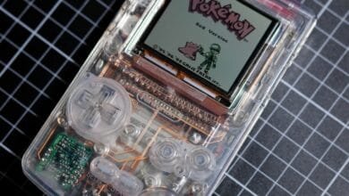 Close-up of a transparent Game Boy showing its internal components, displaying the Pokémon Red Version title screen.