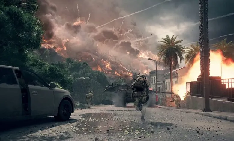 Soldiers run through a war-torn street amidst explosions and fire, a dramatic scene from a video game.