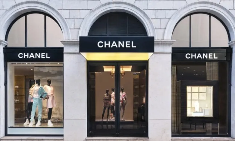 Chanel boutique storefront with mannequins displaying clothing in the windows.