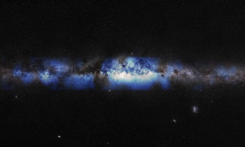 Stunning view of the Milky Way galaxy, showcasing its swirling dust and gas clouds in shades of blue and gray against a dark, star-studded background.