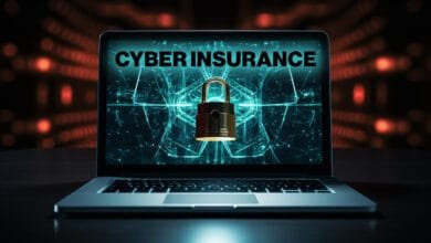 Laptop screen shows 'Cyber Insurance' with a padlock graphic, symbolizing digital security and protection.