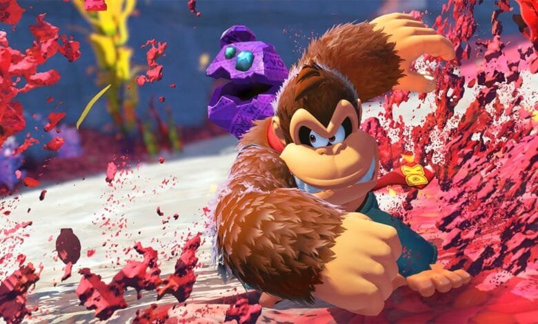 Donkey Kong punches a purple crystal creature amidst a vibrant red explosion.