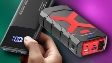 Two portable power banks: a black power bank with a digital display and a rugged red and black jump starter.