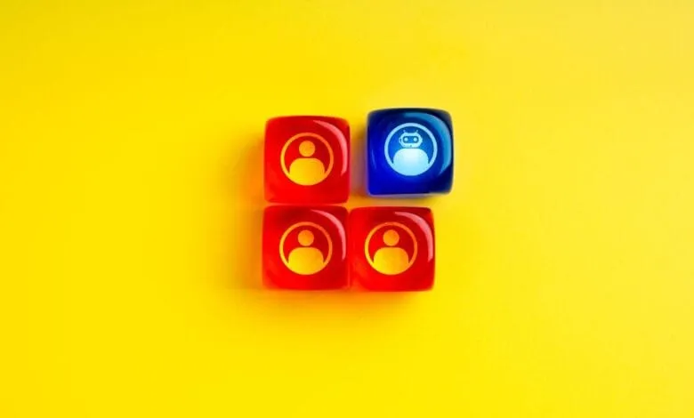 Four red and one blue translucent cubes with person and robot icons against a yellow background, representing AI integration in a team.