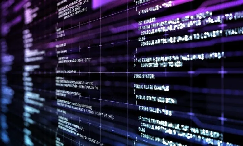 Close-up of lines of code on a dark screen, glowing in shades of purple and blue.