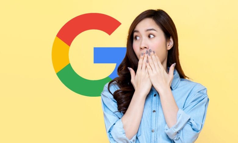 A surprised woman covers her mouth, standing before a large Google logo on a yellow background.