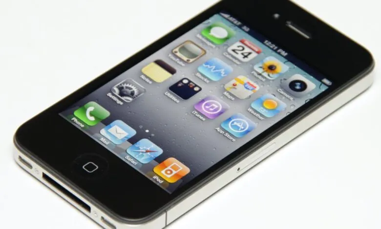 Black iPhone 4 displaying its home screen with various apps like Phone, Mail, Safari, and App Store.