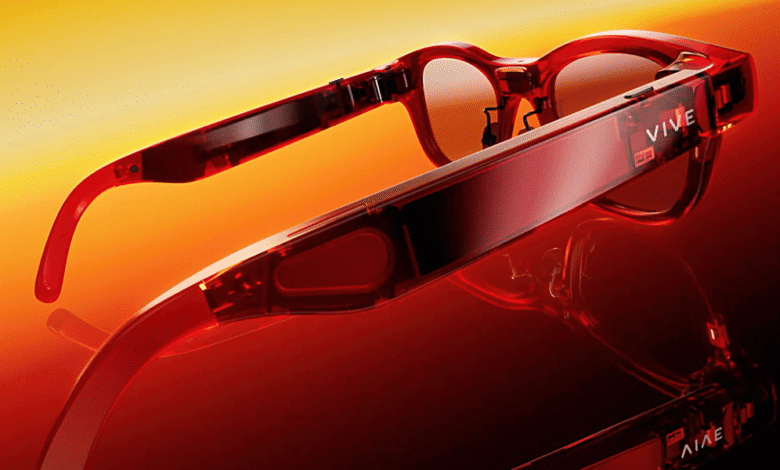 Red HTC Vive XR Elite glasses shown from the side, against a warm orange background.