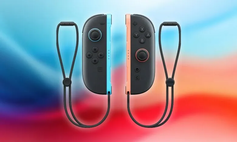 Pair of Nintendo Switch Joy-Con controllers, one blue and one coral, with wrist straps.