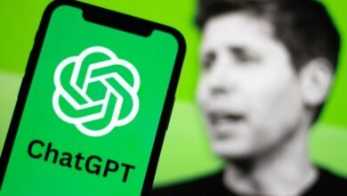 ChatGPT app on a smartphone with Sam Altman, OpenAI CEO, blurred in the background.