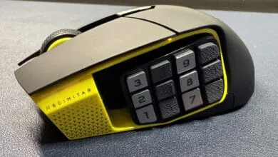 Close-up of a black and yellow gaming mouse with twelve extra buttons on the side.