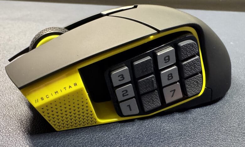 Close-up of a black and yellow gaming mouse with twelve extra buttons on the side.