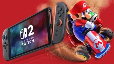 Nintendo Switch OLED model with coral Joy-Cons, showcasing Mario Kart gameplay.