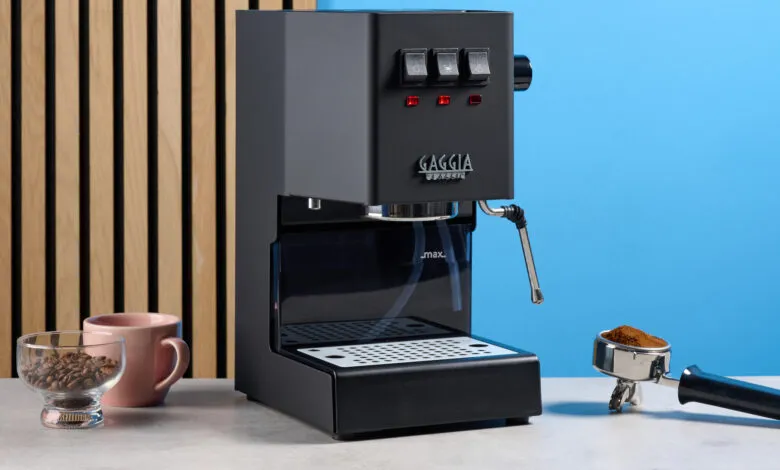 Black Gaggia Classic espresso machine with coffee beans and portafilter.