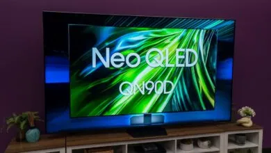 Samsung Neo QLED QN90D TV displaying vibrant green and blue abstract graphics.