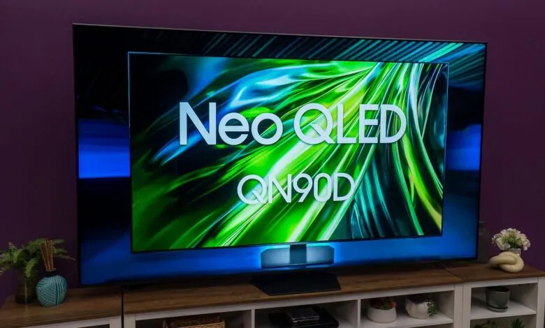 Samsung Neo QLED QN90D TV displaying vibrant green and blue abstract graphics.