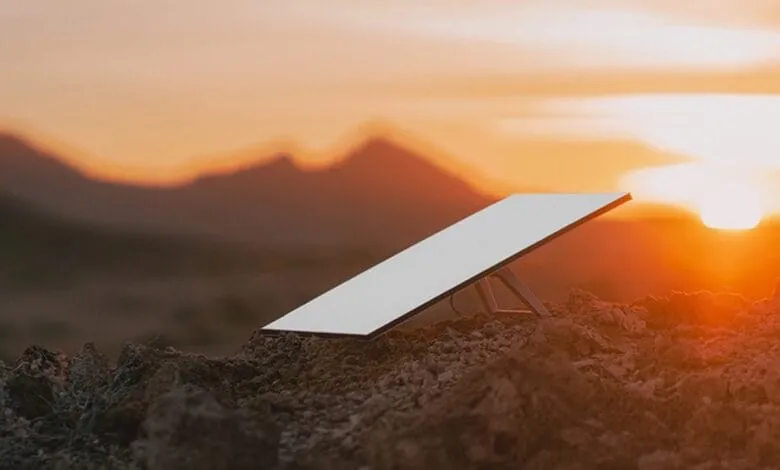 Starlink satellite dish on rocky terrain at sunset.