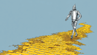 The Tin Man from The Wizard of Oz walks down a damaged yellow brick road.