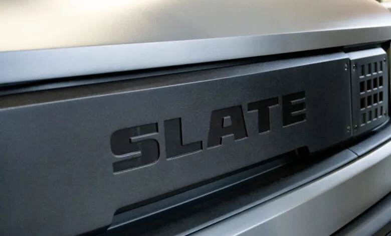 Close-up of the Slate logo on a dark gray vehicle's front grill.