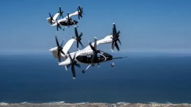 Two Joby Aviation electric vertical takeoff and landing (eVTOL) aircraft flying over a coastline.