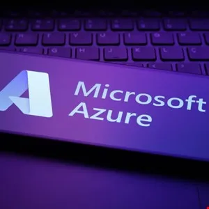 Microsoft Azure logo on a laptop keyboard, illuminated in purple.