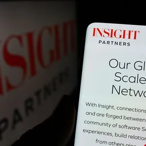 Insight Partners logo displayed on a smartphone screen showing an article about their global scale network.