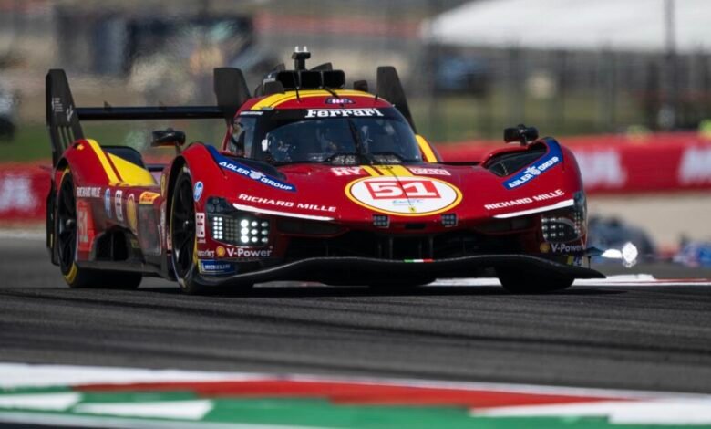 Ferrari 499P race car with number 51 speeding on a race track.