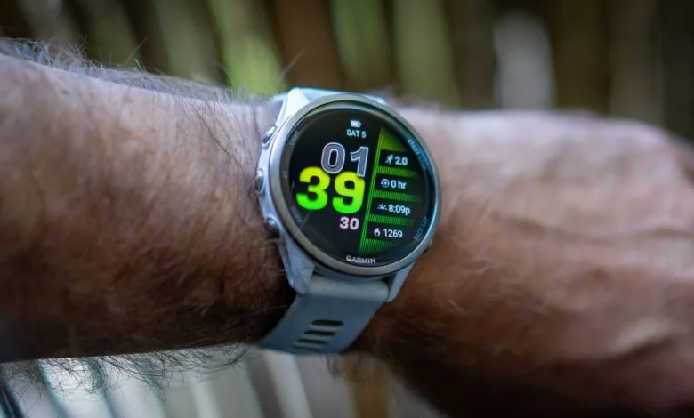 Close-up of a person's wrist wearing a Garmin Forerunner 970 smartwatch displaying workout data.
