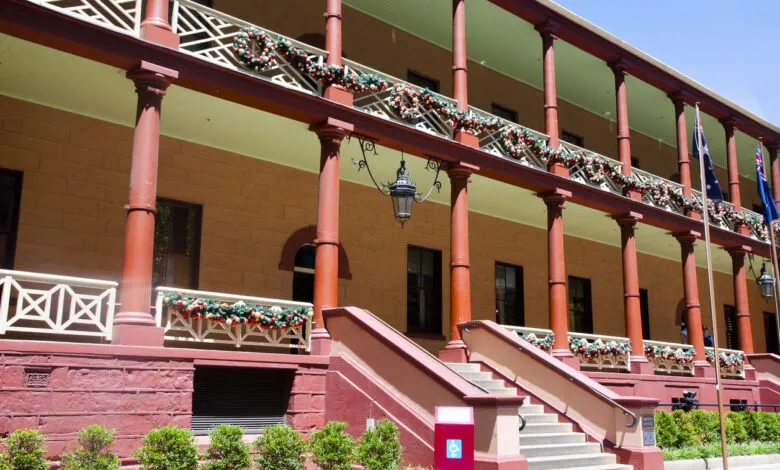 Festive facade of the New South Wales Parliament House in Sydney, Australia, adorned with Christmas decorations.