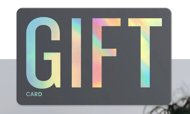 Modern gift card design with iridescent 'GIFT' lettering on a dark gray background.