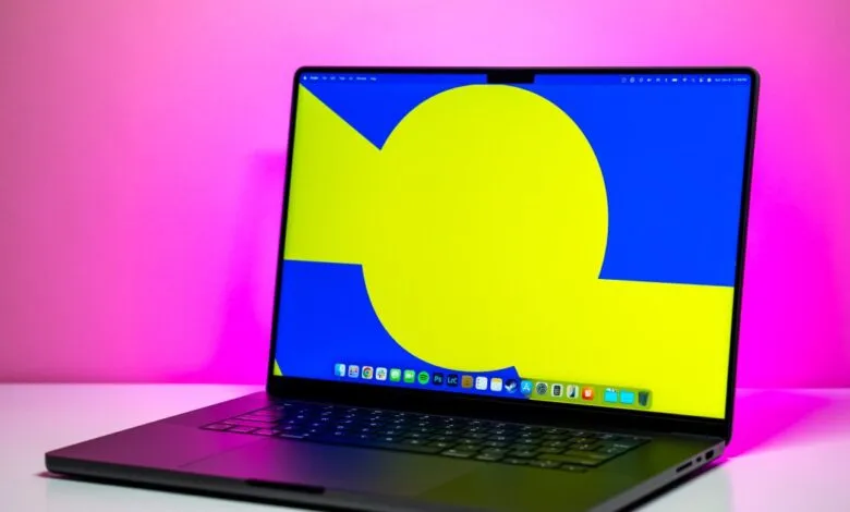 Apple MacBook Pro with vibrant yellow and blue abstract wallpaper.