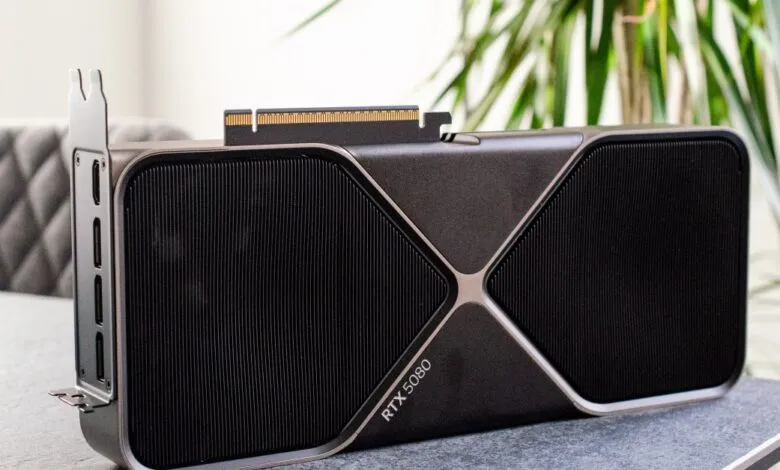 Nvidia RTX 5080 graphics card on a table, sleek dark gray design with subtle metallic accents.