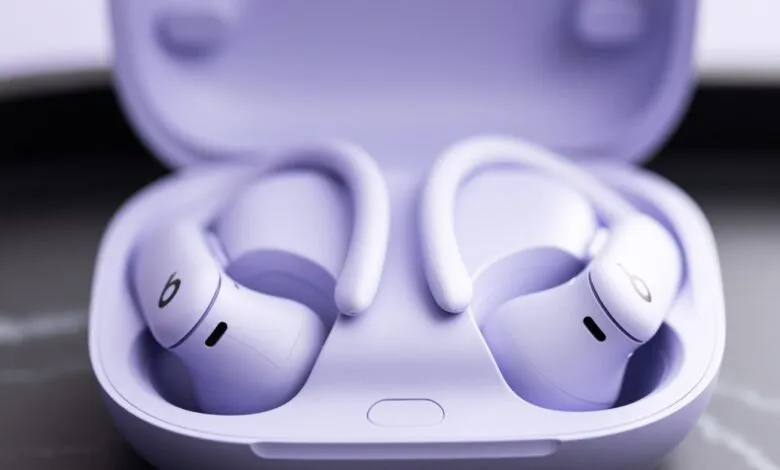 Pair of lavender Powerbeats Pro earbuds in their charging case.