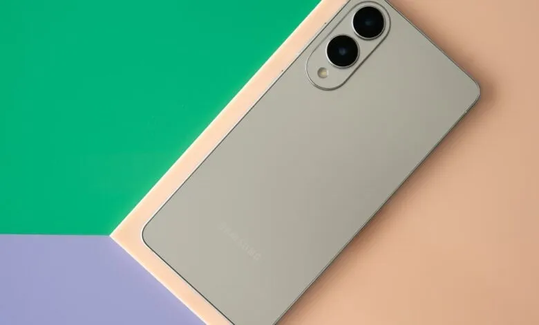 Silver Samsung Galaxy S25 Edge phone rests on a green, peach, and purple background.