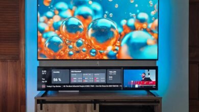 A modern television displaying vibrant abstract art and a news ticker with weather and sports updates.