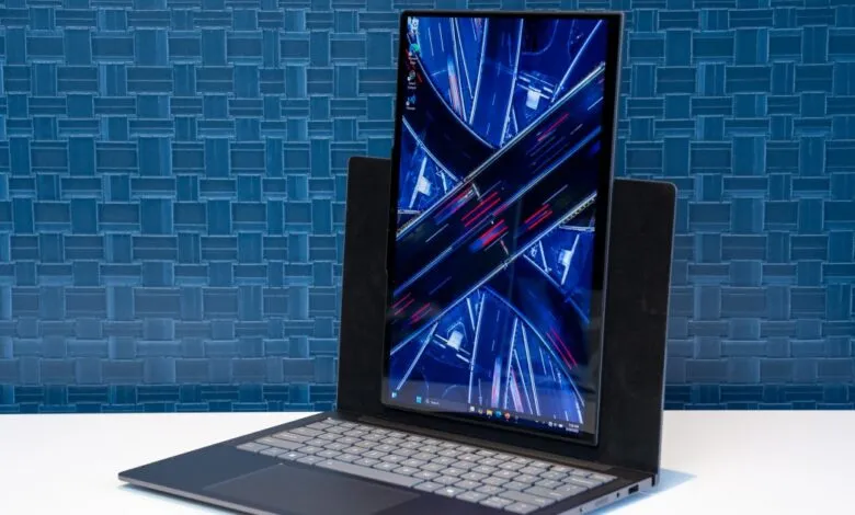 Lenovo ThinkBook VertiFlex laptop with screen raised, displaying a highway aerial shot against a blue background.
