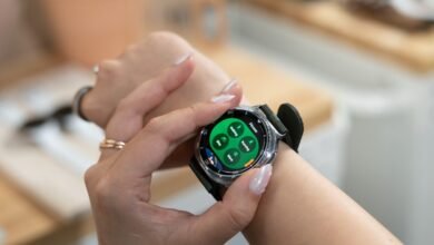 Close-up of a woman's wrist wearing a Samsung Galaxy smartwatch, displaying a fitness tracking interface.