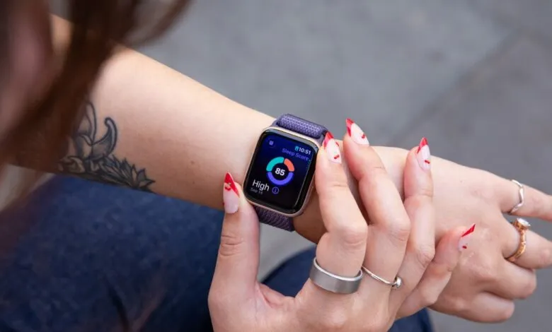 Close-up of a person's wrist wearing an Apple Watch displaying sleep score.