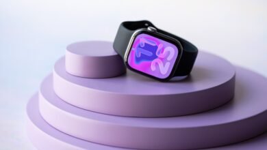 Apple Watch Series 8 with black band rests on a lavender-colored tiered display.