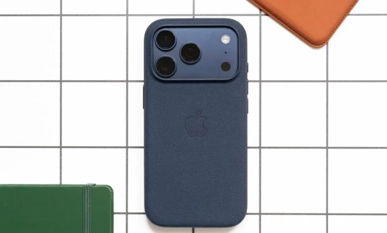 Dark blue iPhone 15 Pro with a textured case and triple camera array.