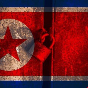 Padlocked North Korean flag; rusty metal texture; symbolizes isolation or secrecy.