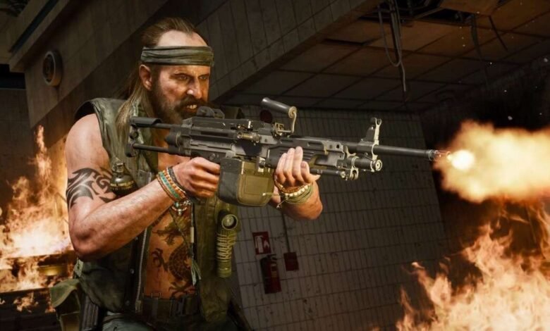 Call of Duty character firing a machine gun amidst flames.
