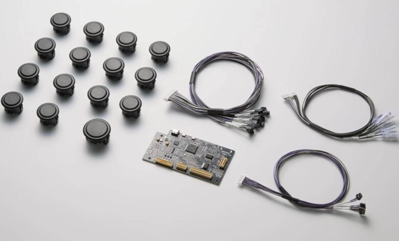 Close-up of arcade buttons, wiring, and a circuit board; components for a gaming machine.