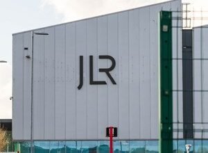 JLR logo on a large modern building exterior.