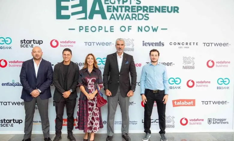 Five individuals stand before a backdrop featuring the Egypt's Entrepreneur Awards logo and various sponsor logos.