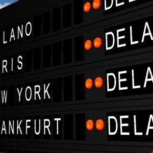Close-up of a departure board showing flight destinations and times.