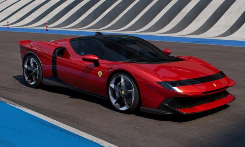 Red Ferrari sports car on a race track.