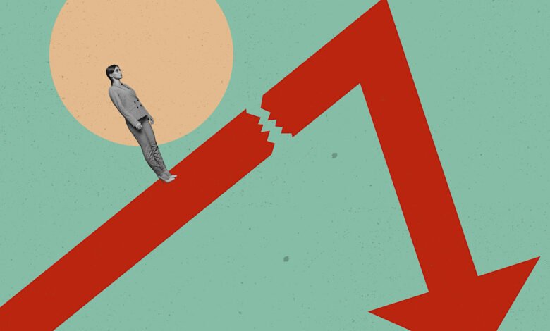 A woman in a suit stands on a broken red arrow pointing down, symbolizing economic downturn or failure.