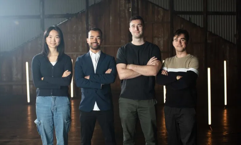 Four diverse professionals stand with arms crossed in a rustic industrial setting, showcasing confidence and teamwork.